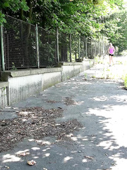 Slim Eveline Neill removes her shorts and perches on a wall to pee outside