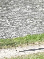 Black haired traveler Lexi looks for a place to pee and urinates below a bridge