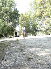 Beautiful black haired Yenna in shorts squats on the trail to take a lengthy pee