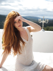 Pale redhead Mia Sollis slides out of a watch thru costume to pose naked on balcony