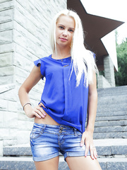 Juvenile golden-haired Elissa K admires her exposed body in a mirror during solo act