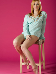 Natural redhead Nikky B slides off a 's short to model in the undressed