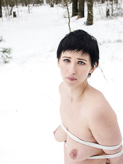 Bare black haired serf fastened in the snow with bare saggy boobs & undressed feet