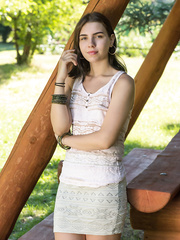 Juvenile brunette hair Zhenya Mille strips for in nature's garb positions on picnic table