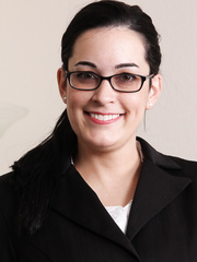 American businesswoman takes off her glasses previous to stripping exposed on desk