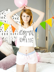 Youthful redhead Mandy removes shirt and shorts along with socks for stripped positions