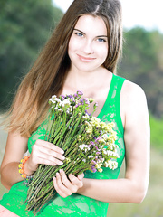 Nice-Looking legal age teenager beauty discloses her large natural breasts as this babe disrobes in a field