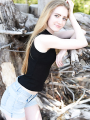 Legal Age Teenager solo gal with lengthy hair Lena Flora receives stripped amid driftwood on beach