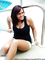 Dilettante babe unbuttons her shorts after stripping to her brassiere by the pool