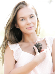 Youthful looking gal flashes her constricted pussy whilst getting bare in the forest