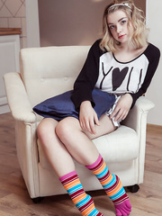 Youthful blond sinks a pair of fingers in her bawdy cleft after stripping to socks