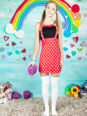 Agreeable juvenile cutie shows her tan lined body in lengthy socks and pigtails