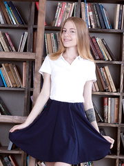 Thin legal age teenager cutie shows off her cotton underclothes during the time that browsing books at library