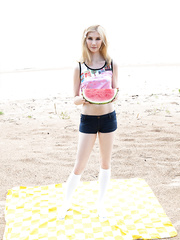 Blond legal age teenager removes white pants and socks in advance of showing her love tunnel on beach