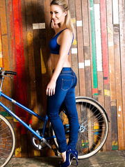 Hot golden-haired beauty Candice Collyer shows off her admirable booty in constricted blue jeans