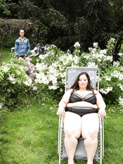 Super sized big beautiful woman Jitka sits on a Peeping Tom's face in the garden