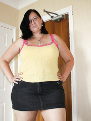 Nasty brunette hair plumper in glasses stripping and licking her nipps