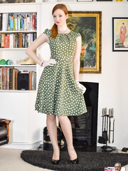 Dressed redhead hikes polka dot costume to flash retro undies and pantyhose in gloves