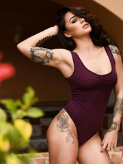 Sexy brunette hair Mica Martinez works her tattooed figure free of a bodysuit