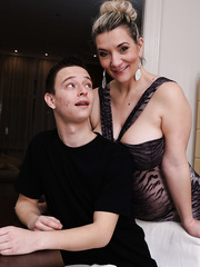 Large titted cougar seduces a juvenile guy for hardcore sex in sleeveless suit