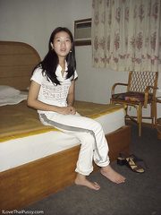 Wicked oriental hottie taking off her garments and posing on the daybed