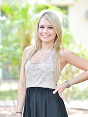 Cute golden-haired angel in dark strap posing for hot upskirt on the street