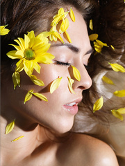 Exposed legal age teenager model covers her pointer sisters and and shaved cunt with flower petals