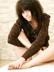 Cute eighteen year old pouts whilst modeling topless in solo act