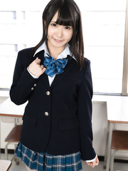 Cute Oriental schoolgirl exposes her scoops and cookie at her desk