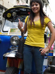 Female Tuk Tuk driver and a Farang ham it up for the camera in a back alley