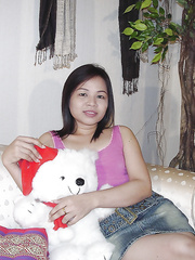 Chunky oriental angel taking off her garments and posing bare on the ottoman