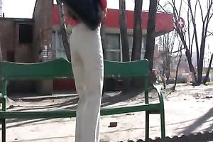Russian white lady Olga in the park urinates in her white panties