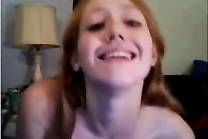Redhead legal age teenager smashes her snatch with a marital-device on livecam