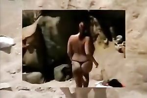 Redhead milf sucks her man's 10-Pounder and takes a ride on it on a beach