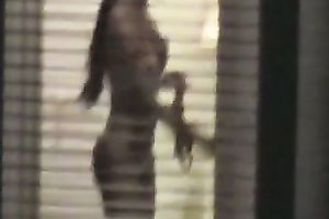 Magnificent wife living next building walks undressed in her apartment