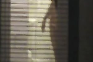 Magnificent wife living next building walks undressed in her apartment