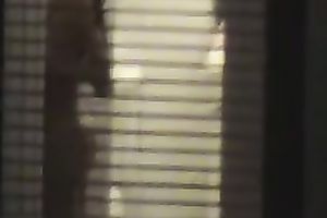 Magnificent wife living next building walks undressed in her apartment