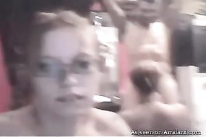 Two slender teenage gals engulf guy's hard dick in turn