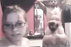 Two slender teenage gals engulf guy's hard dick in turn