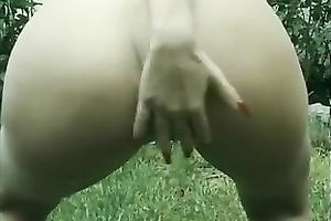 My golden-haired GF undresses in the yard and fingers her twat on a bench