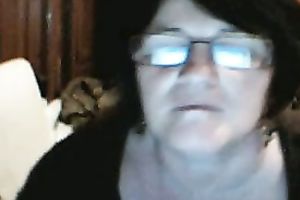 Ugly and bulky web camera granny in glasses plays with her bawdy cum-hole