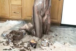 Slutty dilettante woman plays with chocolate syrup in the kitchen