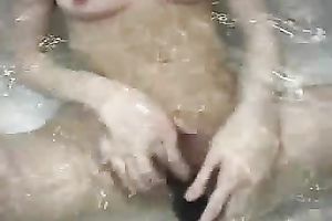 Beautiful eighteen yo dark brown GF pets her cum-hole with fake penis in bathtub