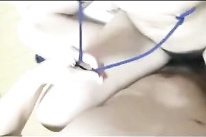Her sharp merry nipps are bound up with ropes and pulled