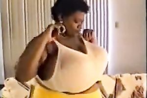 Horny ebon whore proudly flaunts her disproportionately big boobies