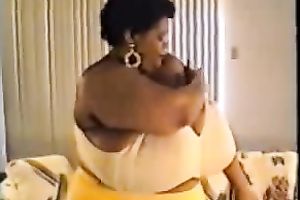 Horny ebon whore proudly flaunts her disproportionately big boobies