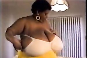Horny ebon whore proudly flaunts her disproportionately big boobies
