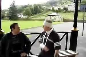 Fat older nurse undresses and gives hand to a patient