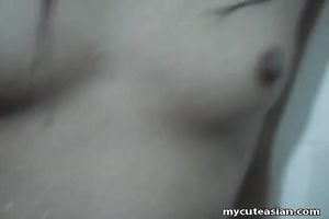 Dirty Asian nympho with small scoops is masturbating in the baths