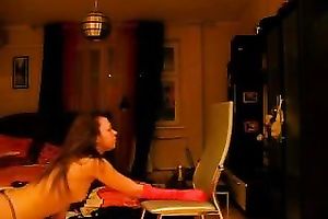 Naughty dark brown doxy stripping near the chair